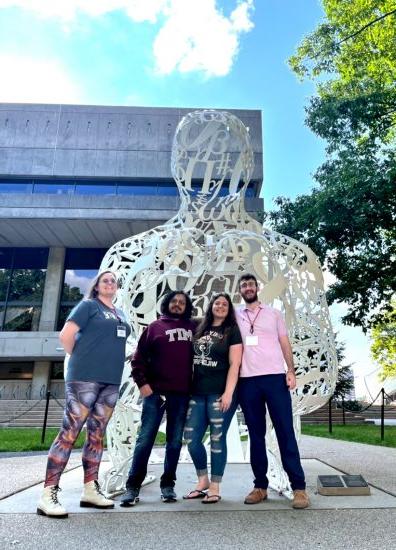 Four A&M-Commerce students in front of MIT art installation